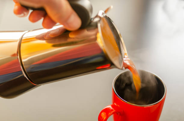 istock Coffee is poured into a cup from a teapot 1286530765