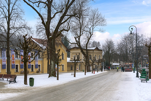 Krynica Zdroj, Poland - January 26, 2020: Tourists walk Dietls boulevards, famous promenade of Krynica on a winter day