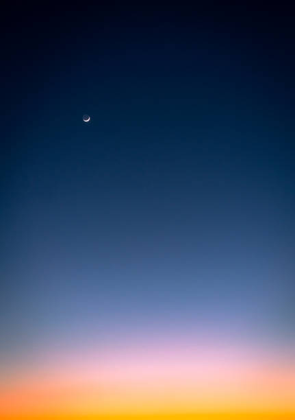 Moonscape at dusk A graduated sky background at dusk, ranging from deep blue to orange by the horizon, with the crescent moon out. night sky only stock pictures, royalty-free photos & images