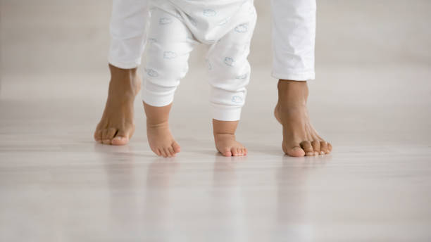 istock Close up of small toddler learn walking 1286532191