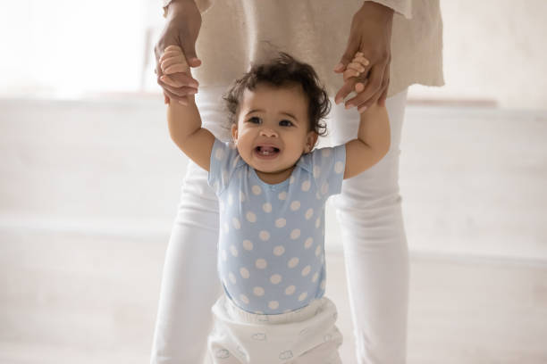 istock Small biracial baby toddler make first steps 1286532195