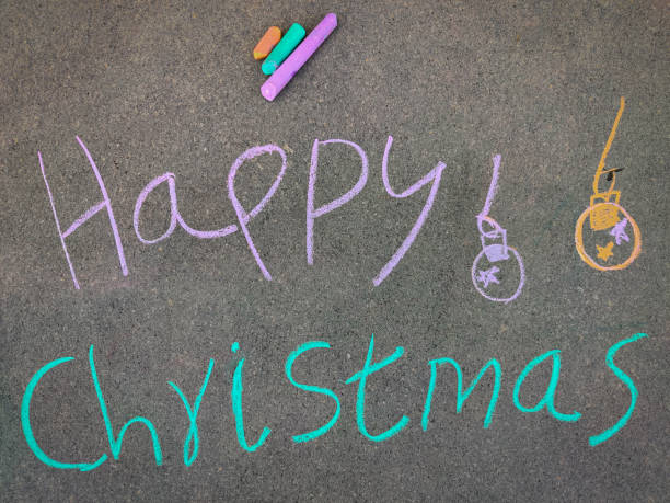 istock The inscription text on the grey board,Happy Christmas with jingle bells. Using color chalk pieces. 1286533309