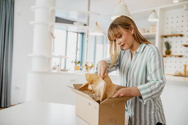 istock Young woman unpack the package she ordered online 1286533908