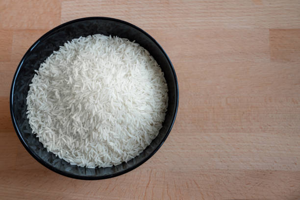 istock Rice in a bowl on wooden table background 1286534106