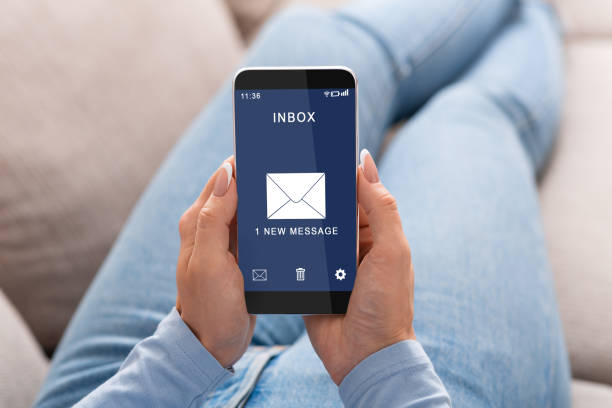 istock Woman Reading E-Mail Message On Smartphone Sitting On Couch Indoor 1286535125