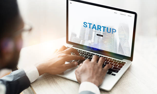 istock Online business concept. Unrecognizable black entrepreneur using website for STARTUP projects on his laptop, collage 1286535143