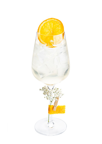 White wine spritzer alcoholic cocktail in champagne saucer glass isolated on white background