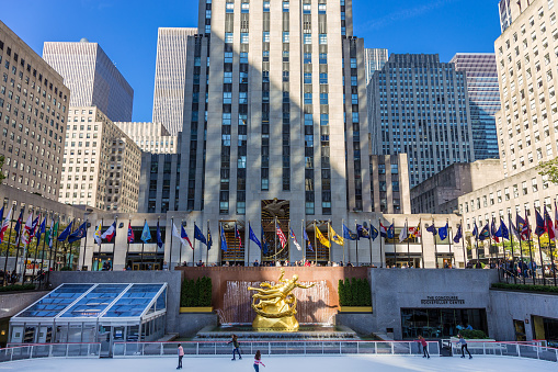 Rockefeller Center, Midtown Manhattan, New York, NY, USA. Rockefeller Center is a complex of commercial buildings  between 48th and 51st streets in New York City. It was declared a National Historic Landmark in 1987. Tourists and New Yorkers are Ice-Skating. Canon EF 24-105mm F/4L IS lens. Canon EOS 6D DSLR with full frame sensor.