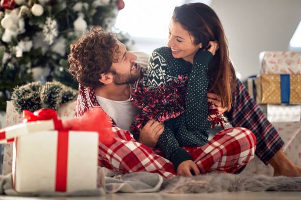 istock Romantic couple sharing gifts on Chrismas morning 1286536651