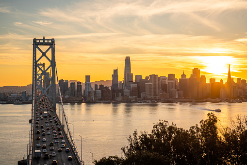 View of San Francisco skyline and the Bay Bridge at sunset.