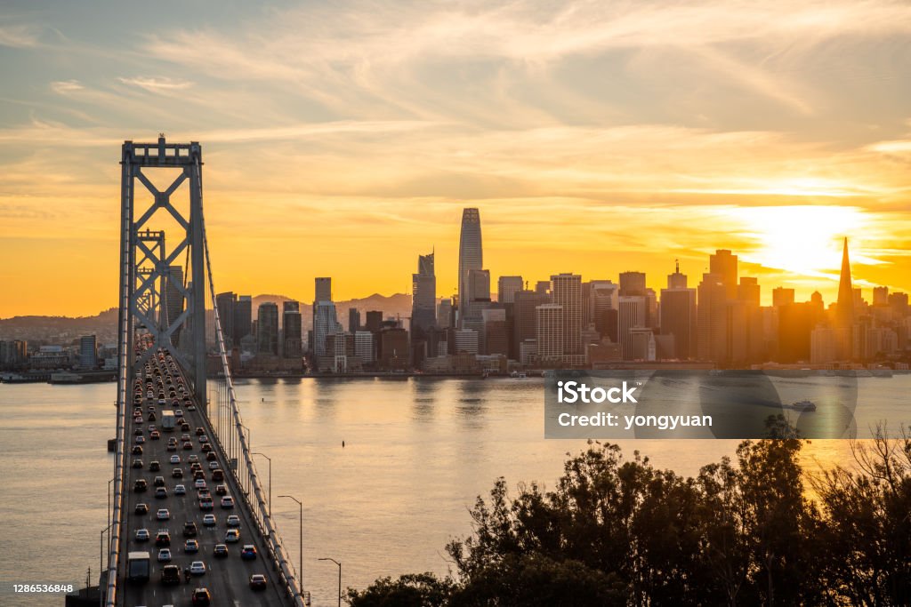 View of San Francisco skyline and the Bay Bridge at sunset View of San Francisco skyline and the Bay Bridge at sunset. San Francisco-Oakland Bay Bridge Stock Photo