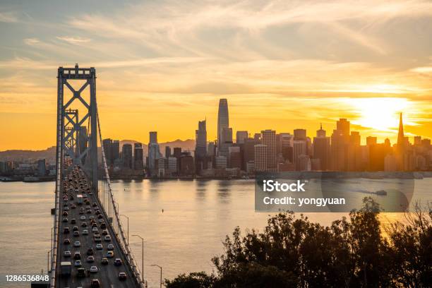 View Of San Francisco Skyline And The Bay Bridge At Sunset Stock Photo - Download Image Now