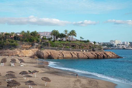 Views of Playa del Duque towards Las Americas coast, a popular beach visited by thousands of tourists yearly, but with only few people now due to the global lockdown, Tenerife, Canary Islands, Spain.