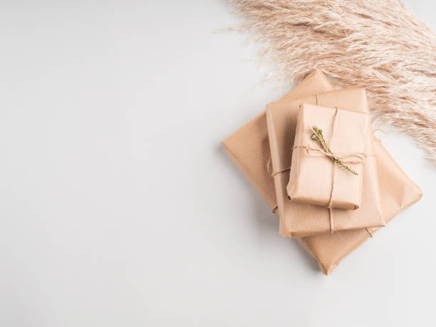 istock Gift boxes wrapped in craft paper with dried flowers 1286538285