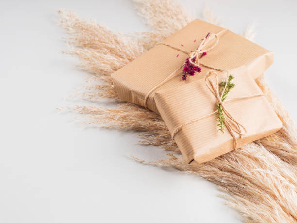 istock Gift boxes wrapped in craft paper with dried flowers 1286539828