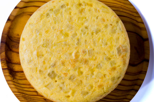 istock Tasty spanish omelette on a wooden tray on white background 1286540415