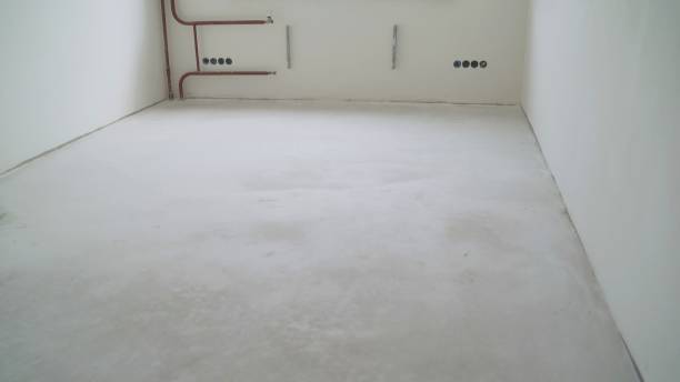istock Floor leveling works. Fresh concrete floor of a construction site. 1286542829