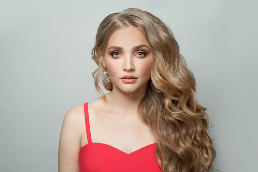 Blonde woman with healthy curly hairstyle on white, fashion portrait