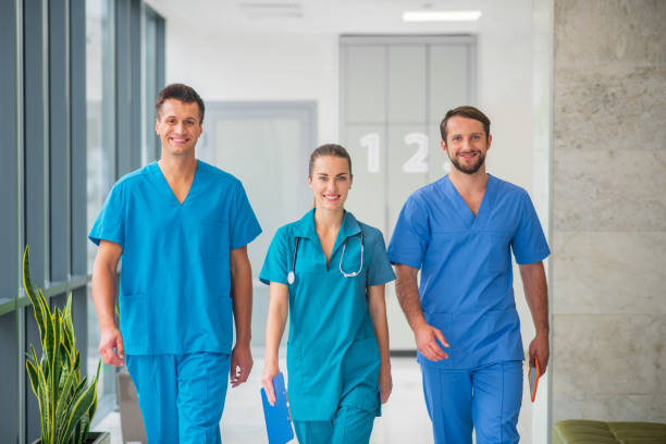 istock Three doctors walking together in the hospital corridor 1286543428