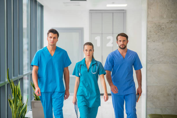 istock Three doctors walking together in the hospital corridor 1286543431