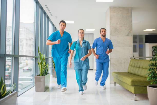 istock Three doctors running through the hospital corridor being in a hurry 1286543441