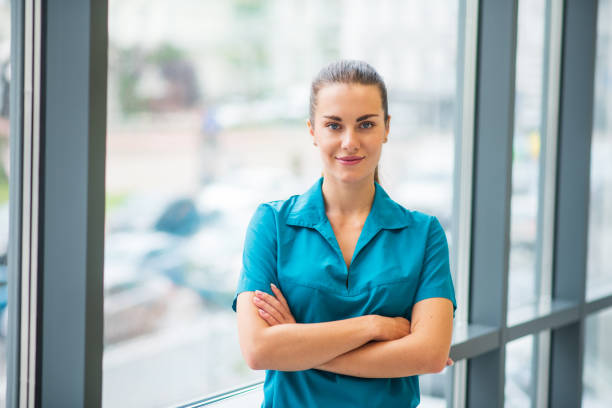 istock Pretty young female doctor in blue uniform smiling nicely 1286543508