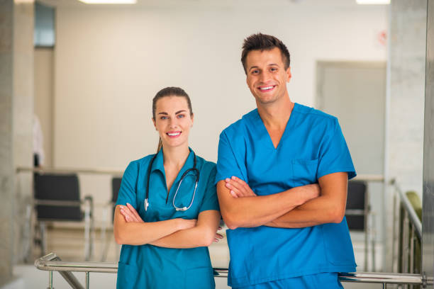 istock Two doctors standing with arms crossed and smiling 1286543513