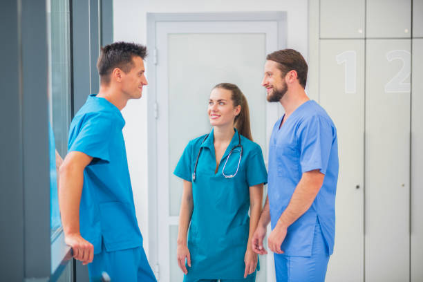 istock Group of doctors talking in the corridor and feeling positive 1286543516