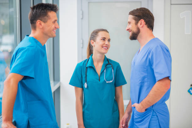 istock Group of doctors talking in the corridor and feeling positive 1286543522