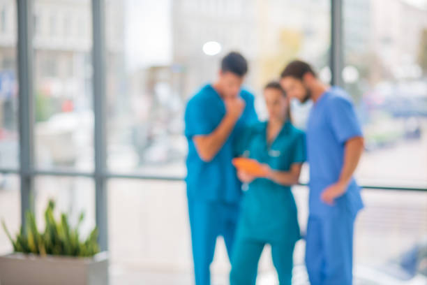 istock Group of doctors watching something on tablet and looking interested 1286543534
