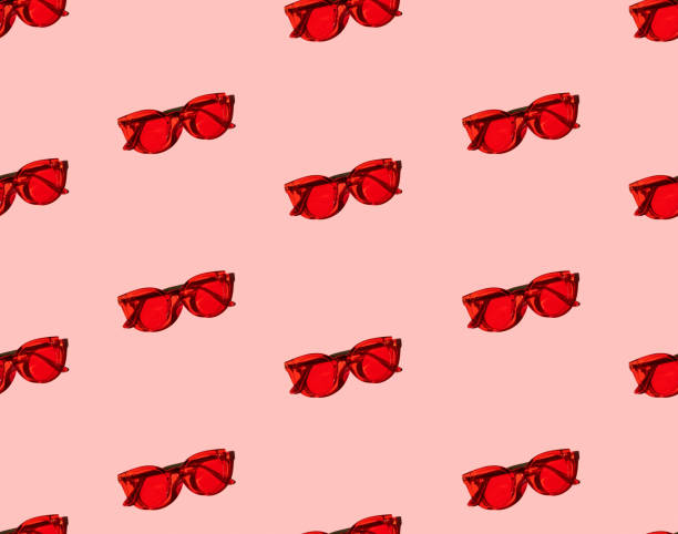 istock Seamless pattern with trendy modern red sunglasses on pink background. 1286543670