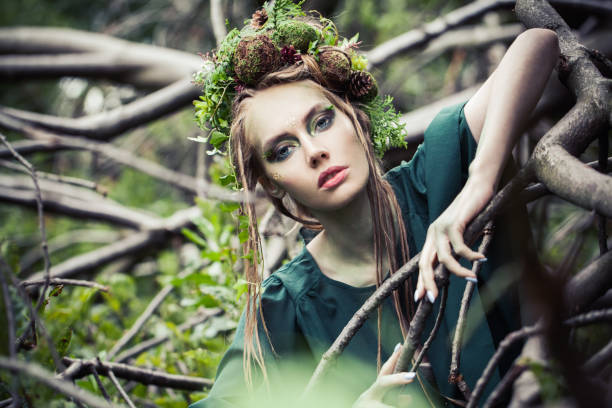 istock Perfect woman witch with leaves and tree branches outdoors. Halloween character or Forest soul 1286543707