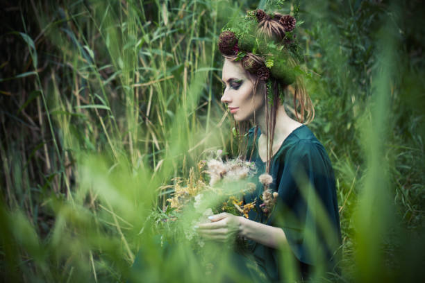 istock Beautiful woman in green grass 1286543738