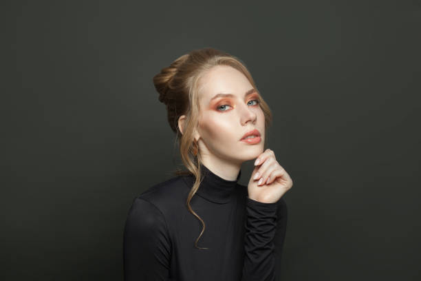 istock Attractive young woman on black background, portrait 1286544476