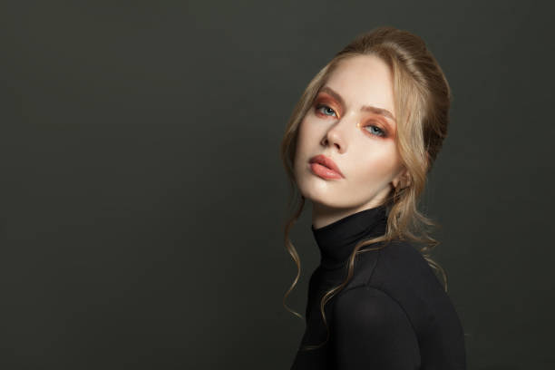 istock Attractive woman model face on black background, portrait 1286544483