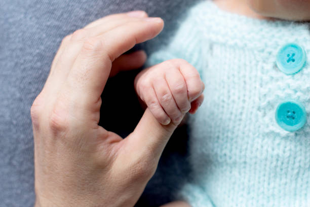 Father is holding a newborn baby in his arms. paternity Dad is holding a newborn baby in his arms. Paternity. High quality photo. father and son paternity stock pictures, royalty-free photos & images