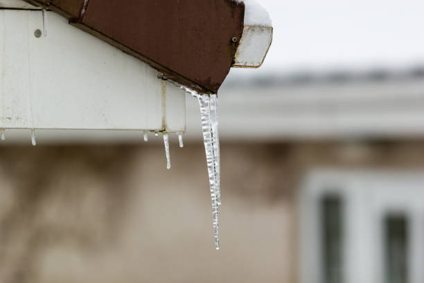istock Dripping icicles on a house roof in winter 1286546743