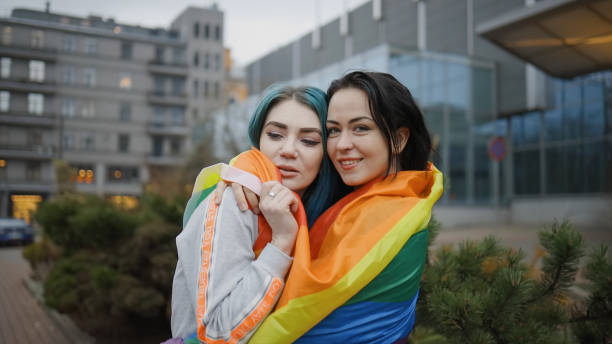 istock Two cute lesbian women hugging in public 1286546815