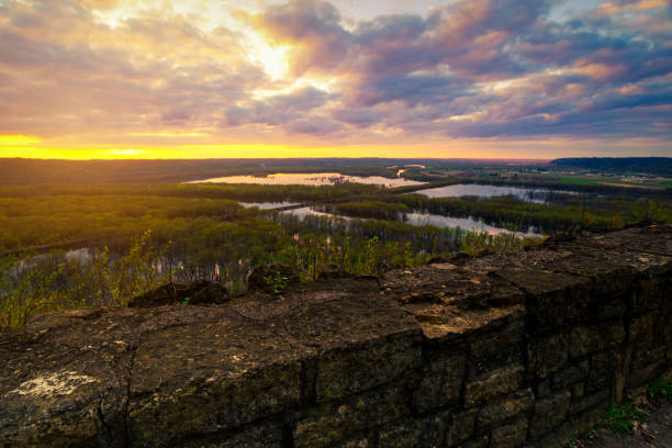 Photo of Landscape view from Wyalusing State Park by capture sunrise or sunset over the lake in cloudy day with old brick wall at foreground.