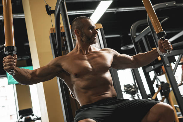 istock Handsome and muscular bodybuilder in a gym during workout 1286548329