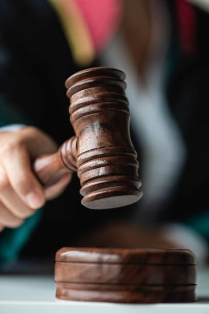 Female Judge Holding Gavel Woman holding gavel. judges stock pictures, royalty-free photos & images