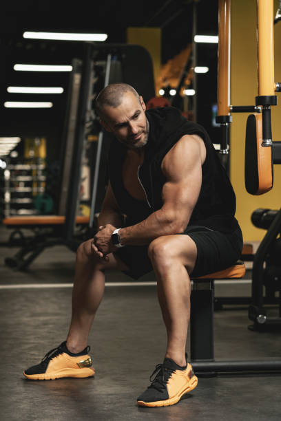 istock Handsome and muscular bodybuilder in a gym during workout 1286548907