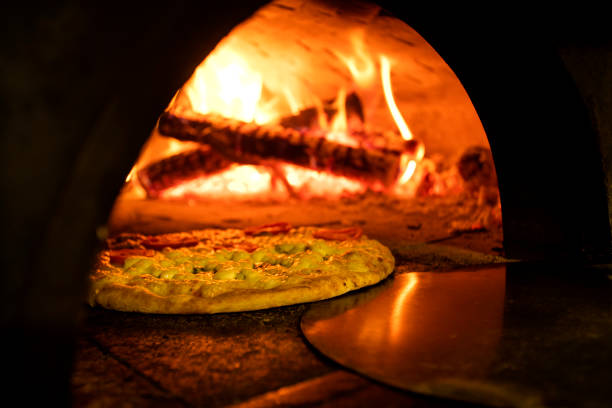 istock Italian pizza inside a wood oven 1286548918