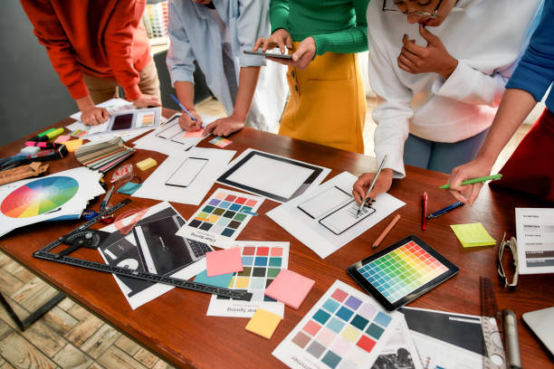 istock Responsive web design. Cropped photo of creative people prototyping new web site design for a client while having a meeting in the modern office. Creative agency concept 1286548923