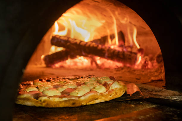 istock Italian pizza inside a wood oven 1286549107