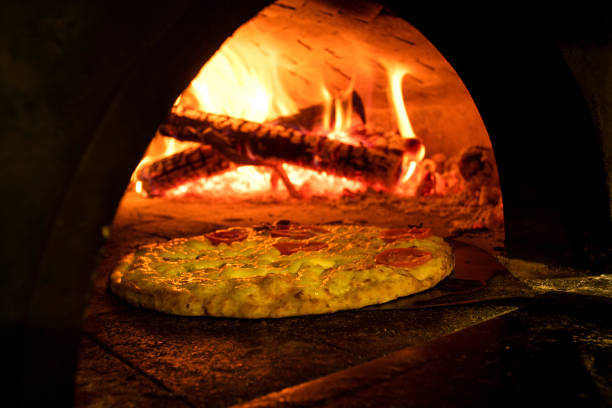 istock Italian pizza inside a wood oven 1286549143