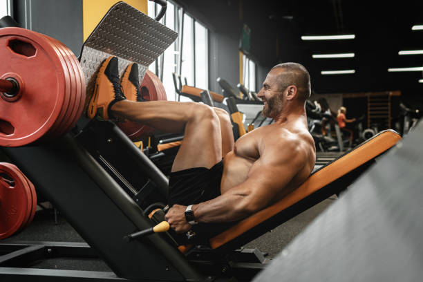 istock Bodybuilder doing a seated leg press exercise in a gym 1286549298