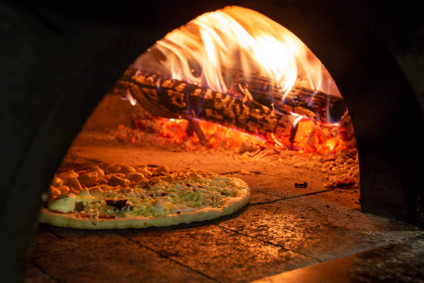istock Italian pizza inside a wood oven 1286549343