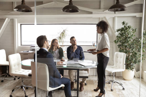 istock African ethnicity female business trainer educating interested diverse manager. 1286549404