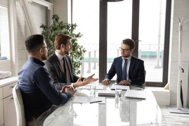 istock Confident motivated diverse businessmen discussing project. 1286549419
